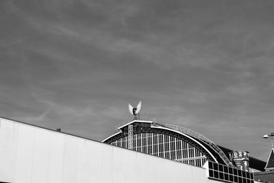 Low angle view of building against cloudy sky
