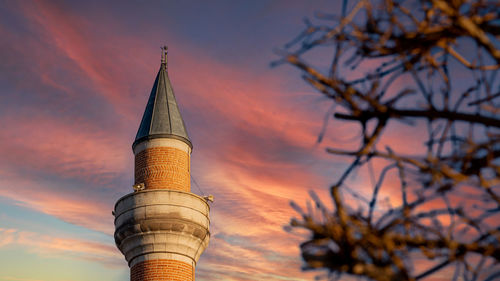 Low angle view of tower against sky during sunset