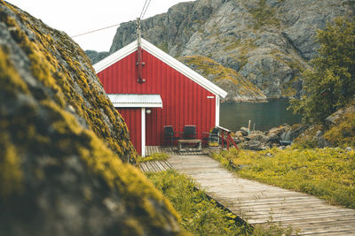 View of house by building against sky