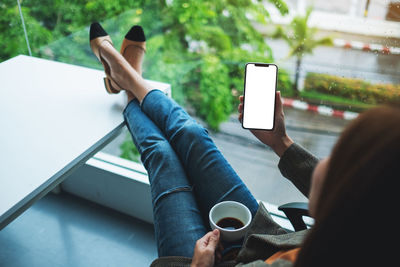 Midsection of woman using mobile phone