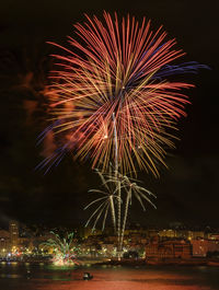 Firework display in city at night