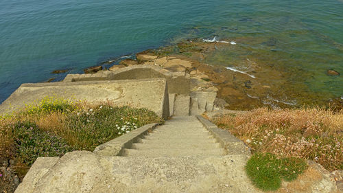 High angle view of footpath by sea