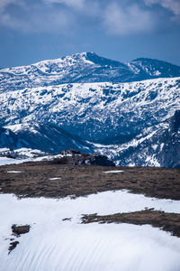 Scenic view of snowcapped mountains against sky