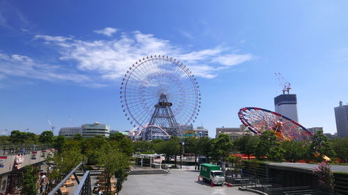 Ferris wheel in city against sky