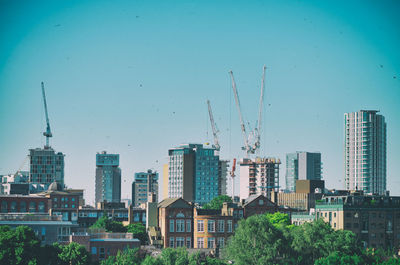 Modern buildings in city against clear sky