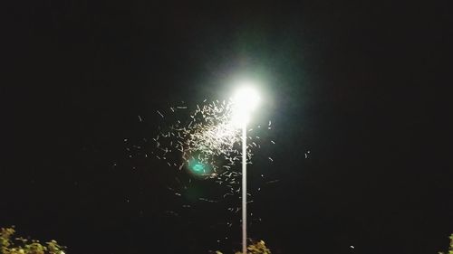 Low angle view of illuminated street light against sky at night