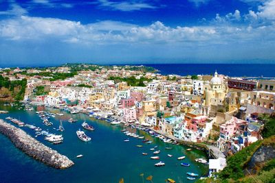 High angle view of townscape by sea against sky