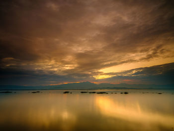 Scenic view of sea against sky at sunset