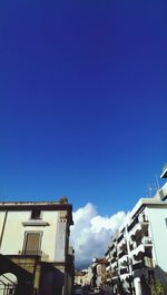Low angle view of buildings against blue sky