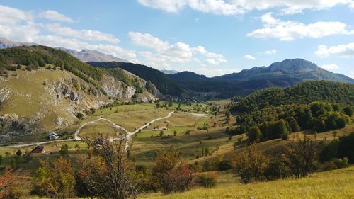 Scenic view of landscape and mountains against sky