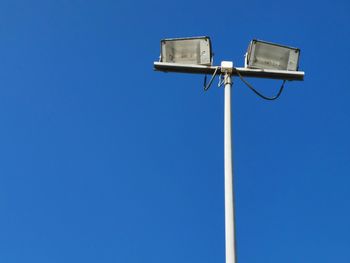 Low angle view of street light against clear blue sky