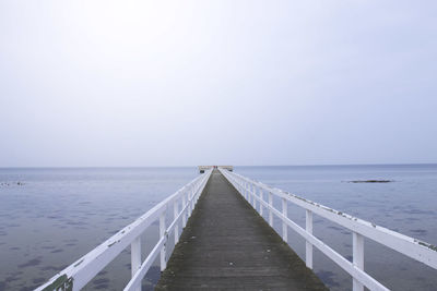 Pier over sea against clear sky