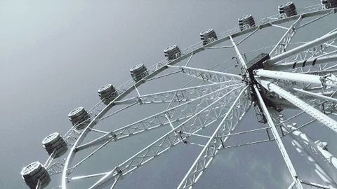 LOW ANGLE VIEW OF FERRIS WHEEL AGAINST THE SKY