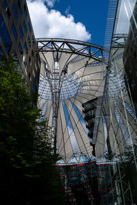 Low angle view of bridge against cloudy sky