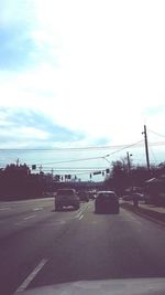 Cars on road against sky