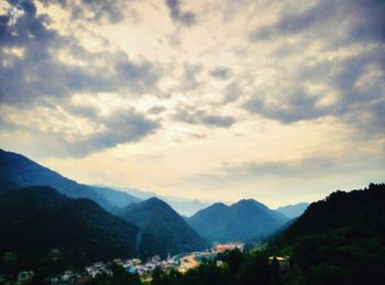 Scenic view of mountains against cloudy sky