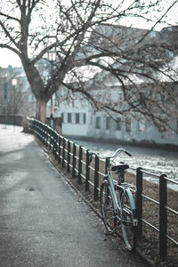 Bicycle on bridge over canal in city