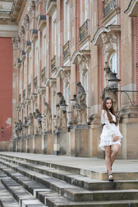Full length of a smiling young woman in city