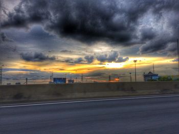 Road against cloudy sky at sunset