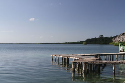 Pier on lake against sky