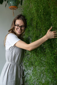 Beautiful woman standing by plants