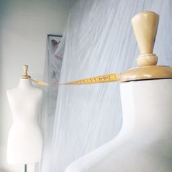 Tape measure hanging on mannequins at store