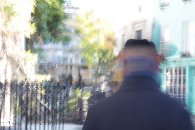 Rear view of a man walking in city