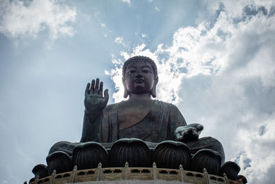 Low angle view of statue against cloudy sky