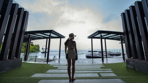 Silhouette of woman standing by railing