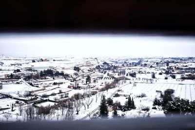 High angle view of snow covered buildings against sky