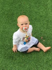 High angle view of cute baby girl on field