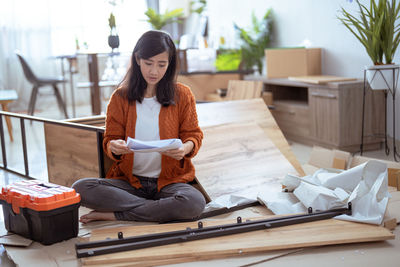 Portrait of young woman sitting at home