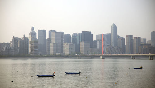 Scenic view of river and buildings against clear sky