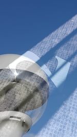 Close-up of airplane over sea against clear blue sky