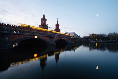 View of oberbaumbrücke with moving subway train over spree river