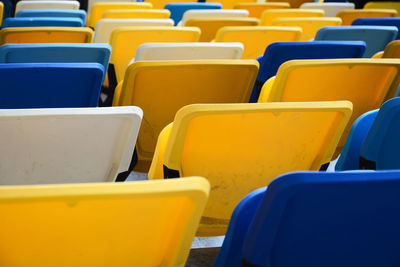 Close-up of empty chairs in row