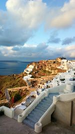 High angle view of sea and buildings against sky