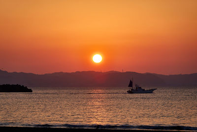 Scenic view of sea against orange sky