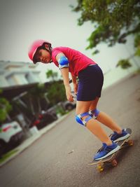 Young woman skateboarding on skateboard