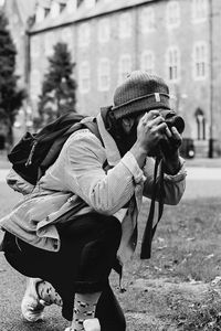 Man photographing with smart phone in city