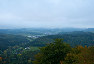 High angle view of green landscape against sky