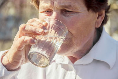 Midsection of woman drinking glass