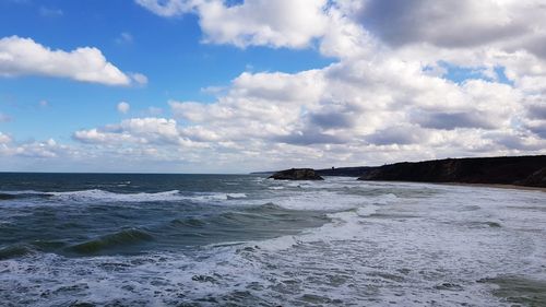 Scenic view of beach and cloudy sky