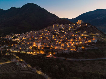 High angle view of illuminated buildings in town against sky