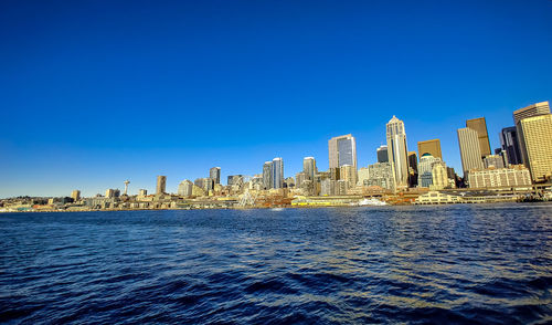 Panoramic view of buildings against blue sky