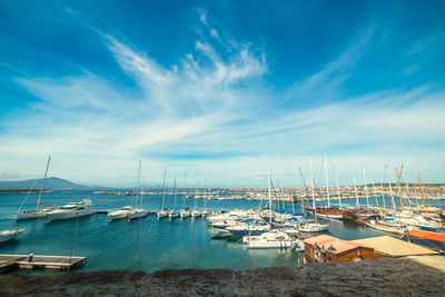 View of marina at harbor against blue sky