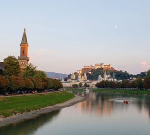 River amidst buildings against sky in city