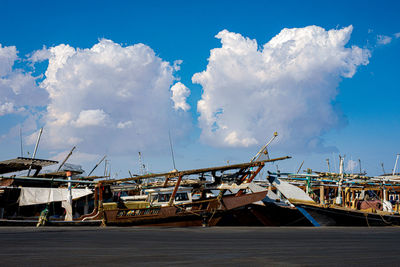 Sailboats moored in sea against sky
