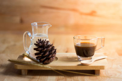 Close-up of black tea and pine cone on table