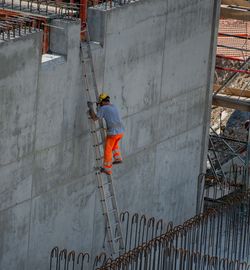 Rear view of man standing on wall